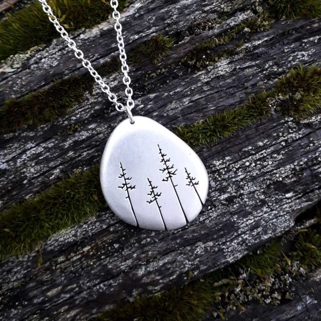 Silver pendant with coniferous trees by Kiley Granberg