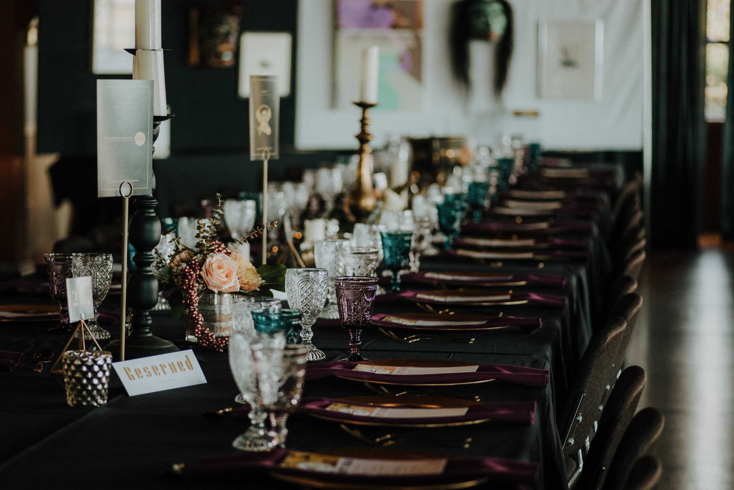 Fancy glasses and plates on a table set up for a party