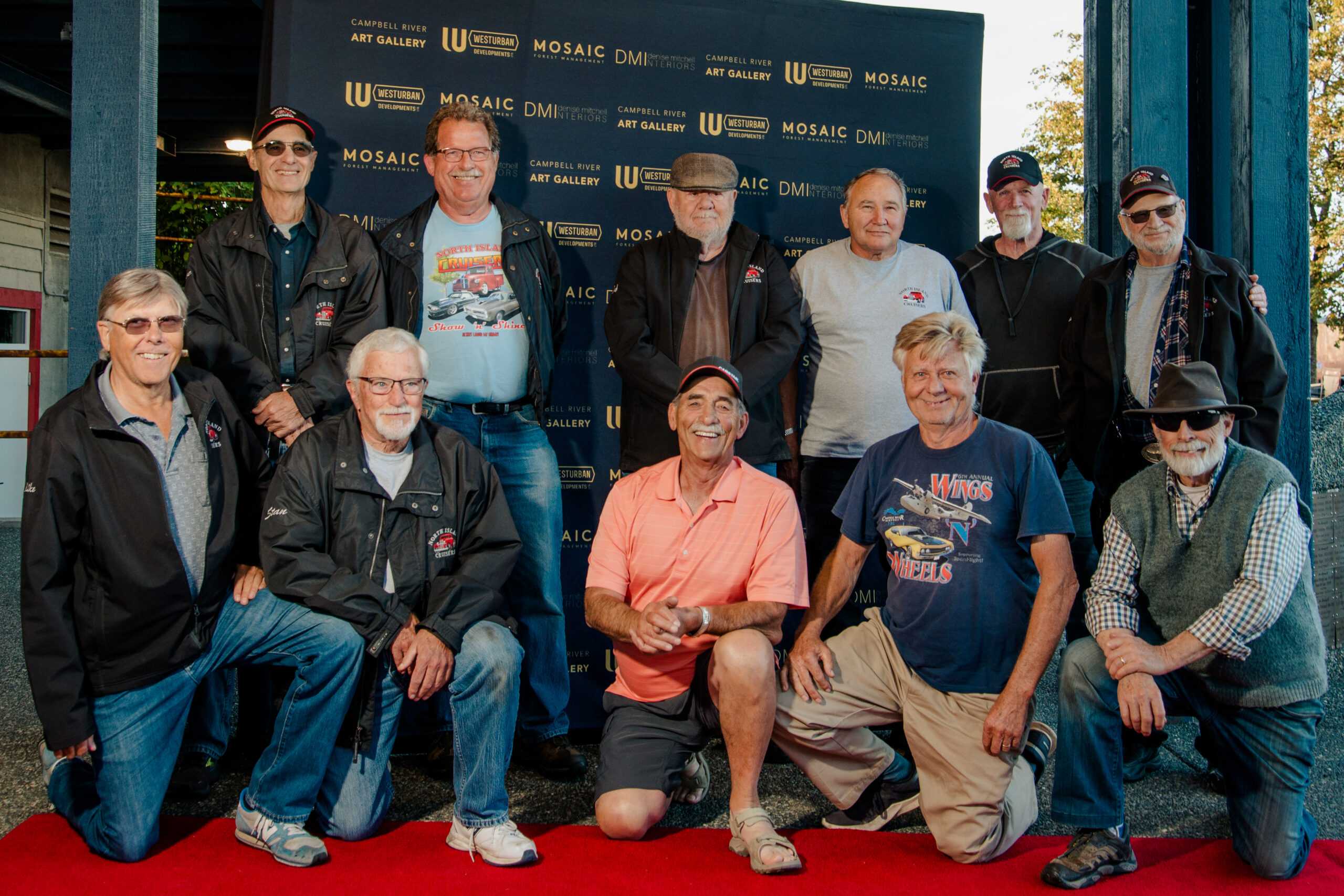 Group of 9 men on the red carpet at a gala