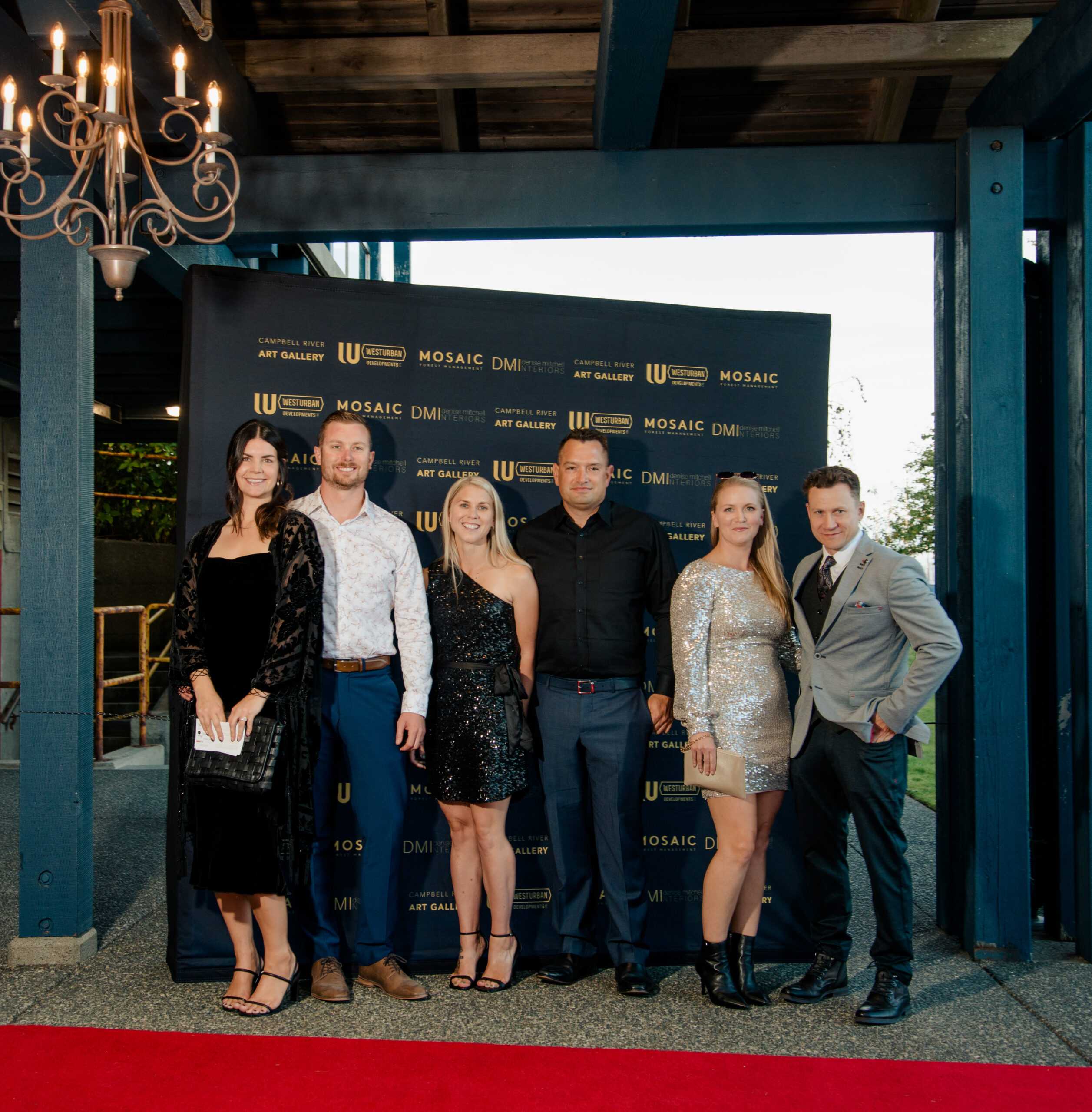 Group posing on the red carpet at a gala